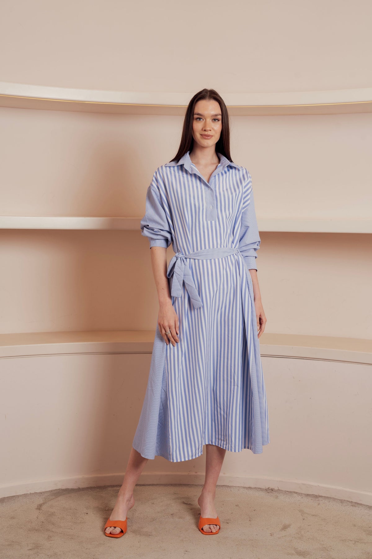 Blue and white striped shirt dress with waist tie and rolled-up sleeves.