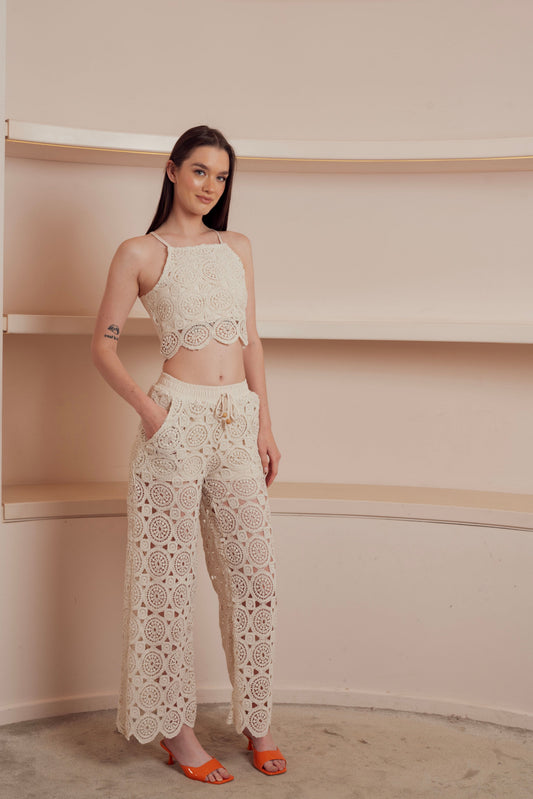 Beige crochet wide-leg pants with drawstring waist.