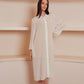 White sheer shirt dress with long sleeves and a pointed collar.